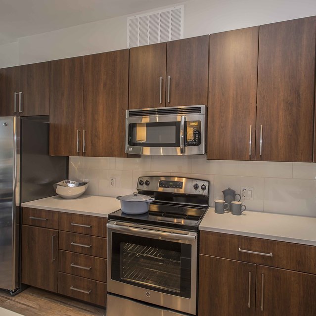 Broadstone Scottsdale Quarter – Contemporary Kitchen with Wood Cabinets and Stainless Steel Finishes